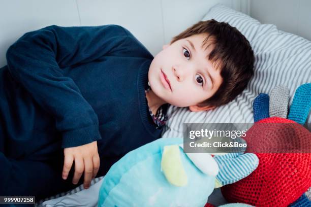 cute little boy playing indoors (on a bed) - click&boo stock pictures, royalty-free photos & images