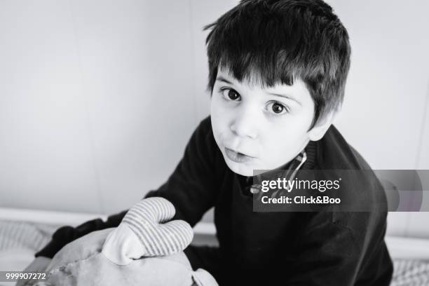 cute little boy indoors staring at the camera - click&boo bildbanksfoton och bilder