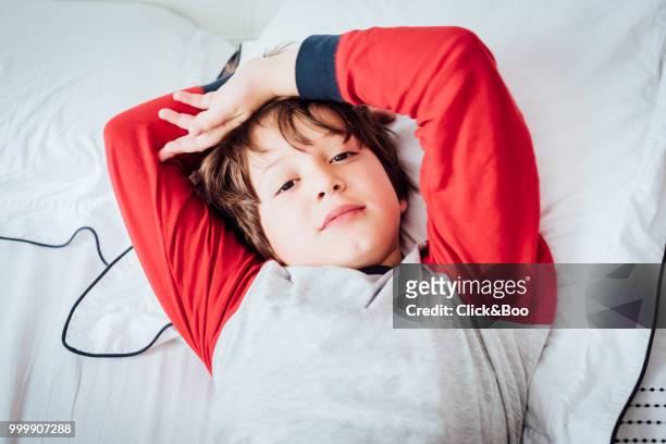 cute boy in bed staring at the camera - click&boo bildbanksfoton och bilder