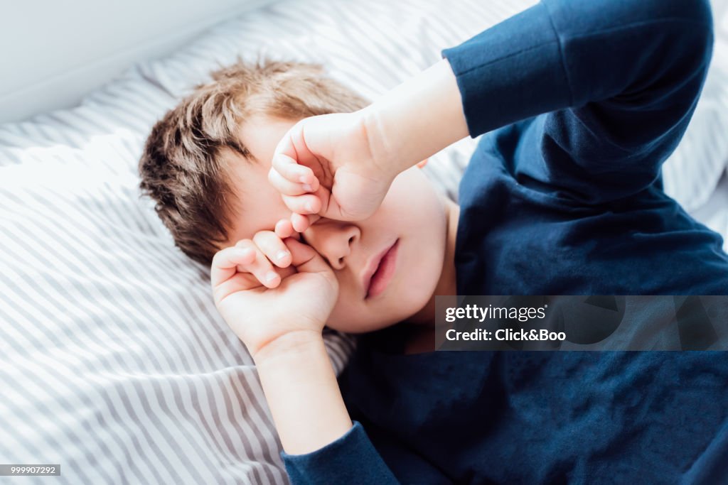 Boy awakening from a deep sleep