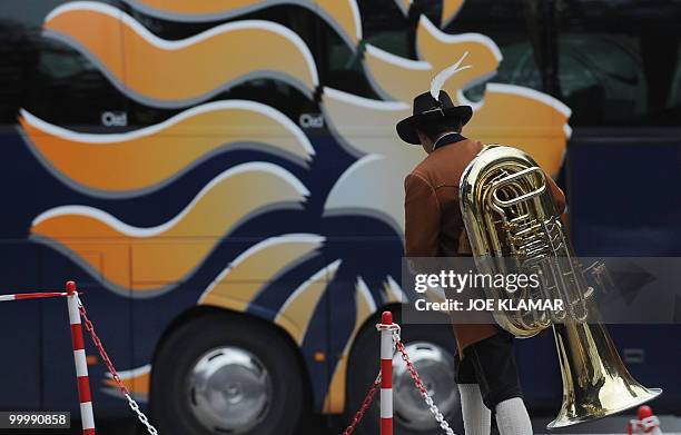 Musician from a Tyrolian brass band walks towards the Netherlands national football team's bus as it arrives at the training camp in Tirolian village...