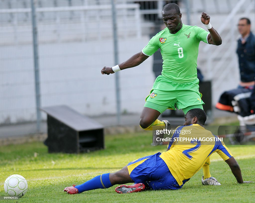 Togolese Toure Assimiou (top) is tackled