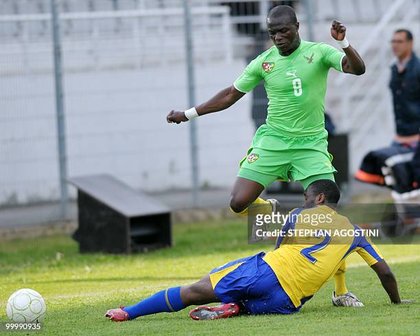 Togolese Toure Assimiou is tackled by Gabonese Alassane Edou Yebe during their friendly football match for the Corsica cup, Togo vs Congo, on May 19...