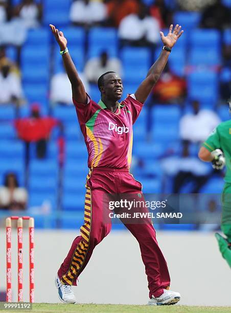 West Indies crickter Kemar Roach celebrates after dismissing South African batsman Johan Botha during the first T20 match between West Indies and...