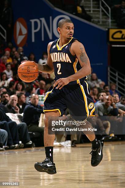 Earl Watson of the Indiana Pacers drives the ball against the Cleveland Cavaliers during the game at Quicken Loans Arena on April 9, 2010 in...