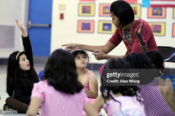 First lady Michelle Obama takes questions from second graders during a physical education class as she visits New Hampshire Estates Elementary...