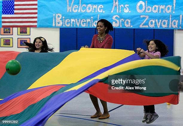 First lady Michelle Obama plays with second graders during a physical education class as she visits New Hampshire Estates Elementary School, which...