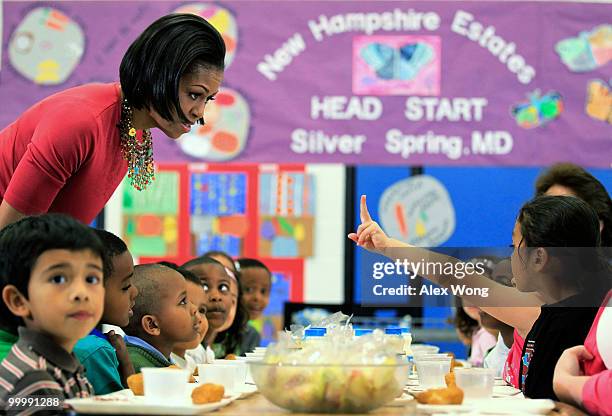 First lady Michelle Obama talks to Head Start students during lunch as she visits New Hampshire Estates Elementary School, which was awarded the...