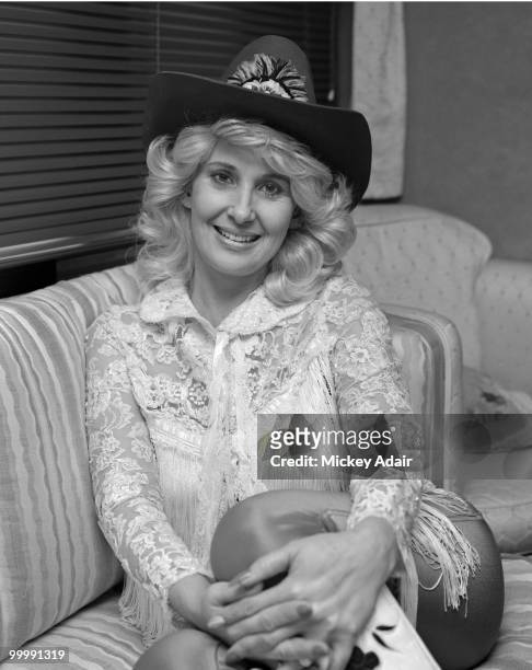 Country singer Tammy Wynette poses for a portrait wearing a cowboy hat in 1982 in Tallahassee, Florida.