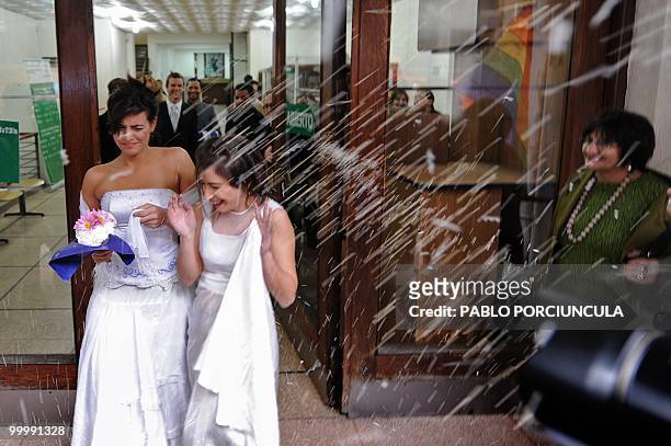 People throw rice to Dennis and Maite, members of the Ovejas Negras gays, lesbians and transvestites organization, cheer after enacted marriages at...