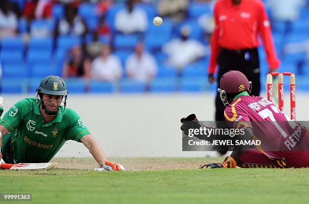 South African crickter Ryan McLaren saves his wicket as West Indies wicketerkeeper Andre Fletcher trying for a run out during the first T20 match...