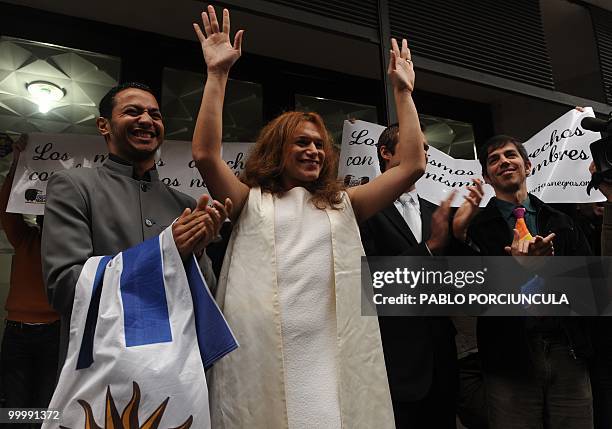 The couples Raul and Fabiana, and Damian and Gonzalo, members of the Ovejas Negras gays, lesbians and transvestites organization, wave to friends...