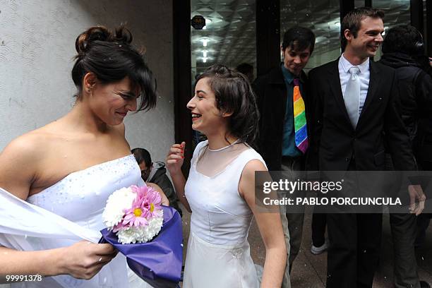 The couples Maite and Dennis, and Damian and Gonzalo, members of the Ovejas Negras gays, lesbians and transvestites organization, cheer after enacted...