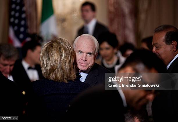 Senator John McCain is hugged by Secretary of State Hillary Rodham Clinton during a luncheon at the US State Department May 19, 2010 in Washington,...