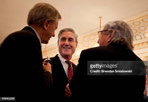 Federal Bureau of Investigation Director Robert Mueller speaks with guests before a luncheon at the US State Department May 19, 2010 in Washington,...