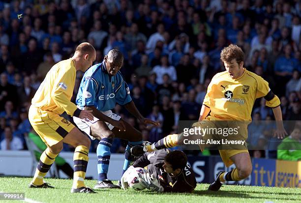 Wimbledon goalkeeper Kelvin Davis, Wayne Brown and Kenny Cunningham of Wimbledon keep out Shaun Goater of Man City during the Nationwide Division One...