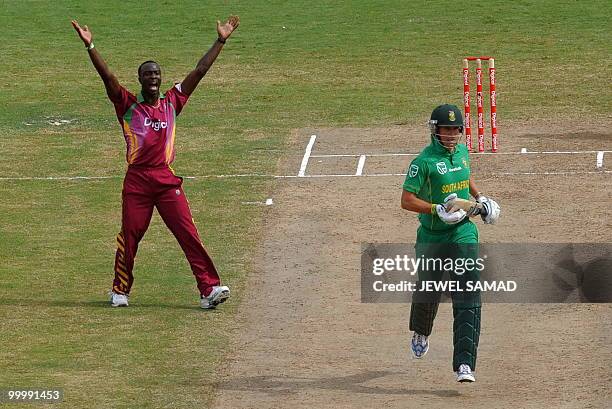 West Indies crickter Kemar Roach celebrates after dismissing South African batsman Johan Botha during the first T20 match between West Indies and...