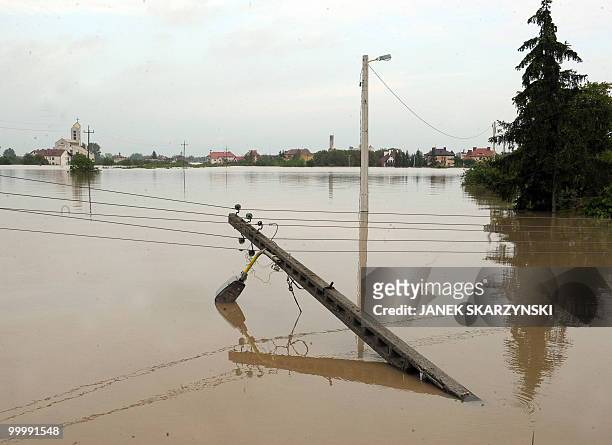 Destroyed electricity pole lies in the flooded district of Sandomierz, central Poland, on May 19,2010. The floods striking southern Poland could...