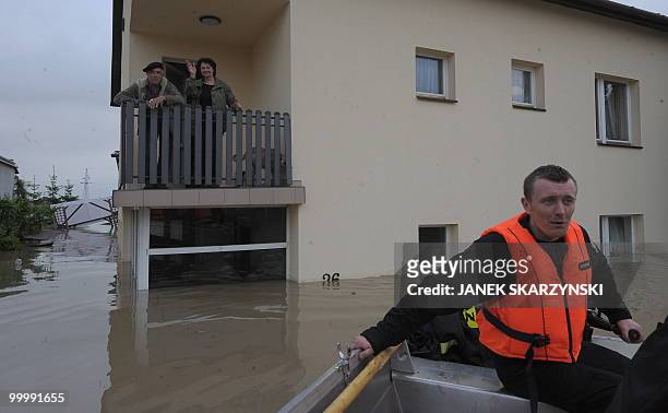 Local residents refuse to be evacuated from their flooded house in the flooded district of Sandomierz, central Poland, on May 19,2010. The floods...