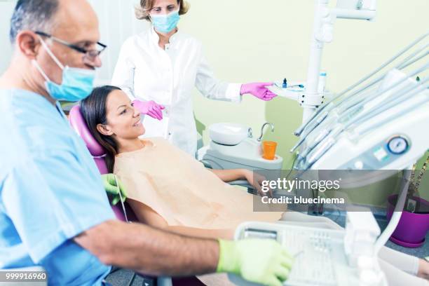 dentist holding dental tool - dental drill stock pictures, royalty-free photos & images