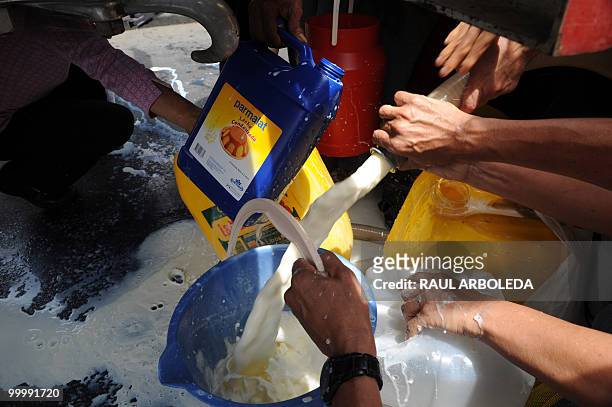 Dairy farmers distribute free milk during a demonstration on May 19, 2010 in Medellin, Antioquia department, Colombia, against a free trade agreement...