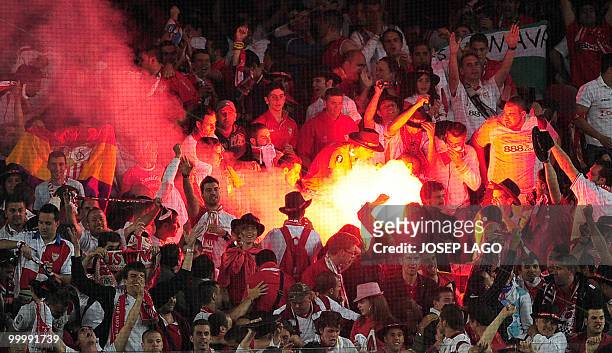 Sevilla supporters light flares after Sevilla's midfielder Diego Capel scored during the King's Cup final match Sevilla against Atletico Madrid at...