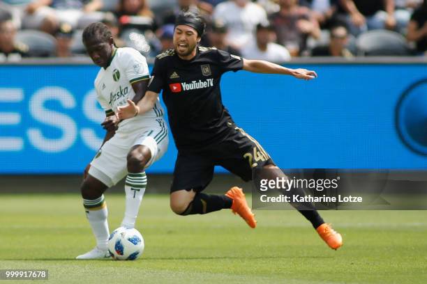 Diego Chara of the Portland Timbers and Lee Nguyen of the Los Angeles Football Club battle for control of the ball at Banc of California Stadium on...