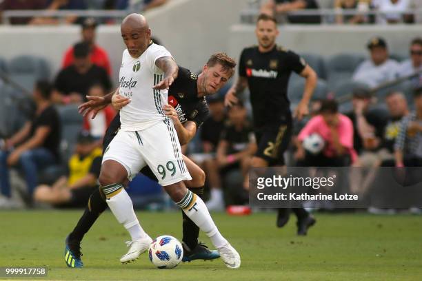 Walker Zimmerman of the Los Angeles Football Club grabs Samuel Armenteros of the Portland Timbers at Banc of California Stadium on July 15, 2018 in...
