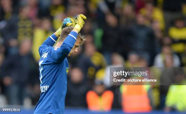 Freiburg's Alexander Schwolow celebrates the 0:0 draw at the end of the German Bundesliga football match between SC Freiburg and Borussia Dortmund at...