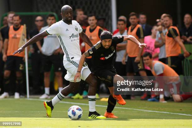 Lawrence Olum of the Portland Timbers and Lee Nguyen of the Los Angeles Football Club battle for control of the ball at Banc of California Stadium on...