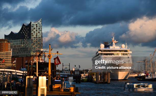 View of the 'Europa 2' cruise ship next to the Elbphilharmonie concert hall during the cruise festival Hamburg Cruise Days at the Elbe river in...