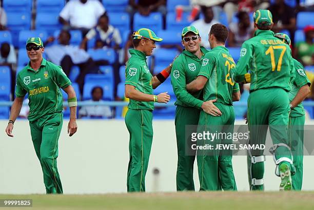 South African cricket team captain Graeme Smith celebrates with teammates after taking a catch to dismiss his West Indies counterpart Chris Gayle...