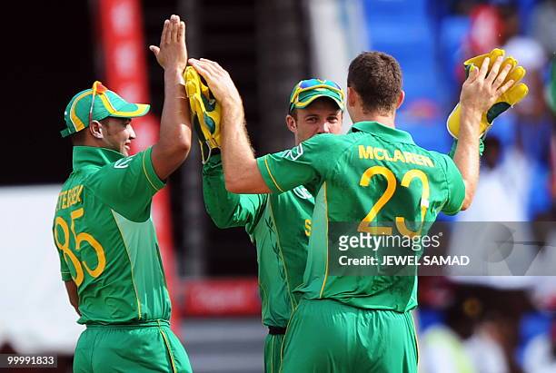 South African wicketkeeper AB de Villiers celebrates with teammates after taking a catch to dismiss West Indies batsman Andre Fletcher during the...