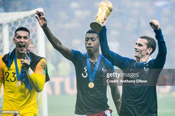 Alphonse Areola, Presnel Kimpembe and Antoine Griezmann of France with the trophy during the World Cup Final match between France and Croatia at...