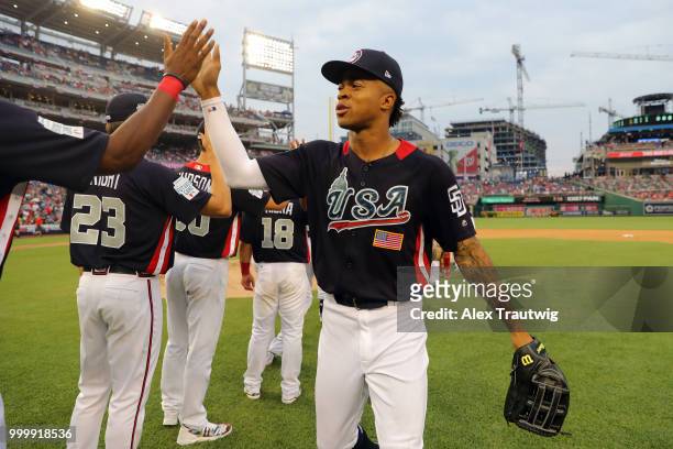 Buddy Reed of Team USA celebrates with teammates after Team USA defeated the World Team in the SiriusXM All-Star Futures Game at Nationals Park on...