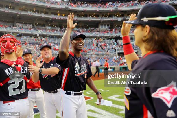 LaTroy Hawkins of Team USA celebrates with members of Team USA after Team USA defeated the World Team in the SiriusXM All-Star Futures Game at...