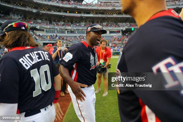 Torii Hunter of Team USA celebrates with members of Team USA after Team USA defeated the World Team in the SiriusXM All-Star Futures Game at...