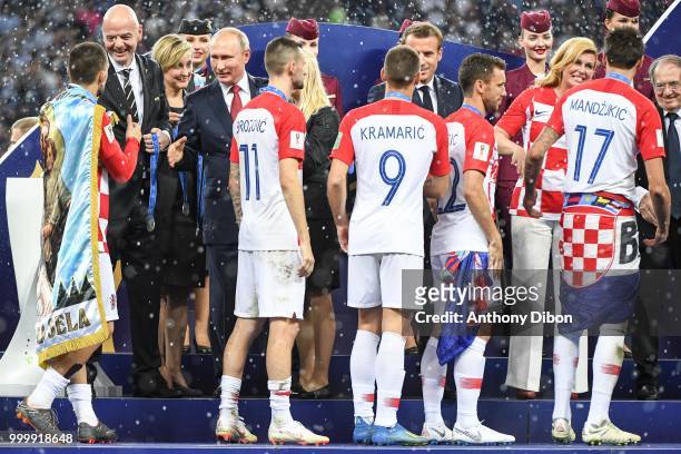 President Gianni Infantino , Russian President Vladimir Putin , French President Emmanuel Macron and Croatia's President Kolinda Grabar Kitarovic...