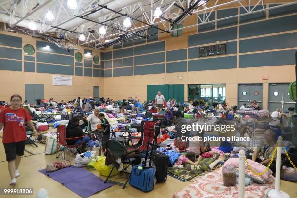 People created small camps on the floor of a gym in Palm Beach County, US, 9 September 2017. Tens of thousands of people have to flee from hurricane...