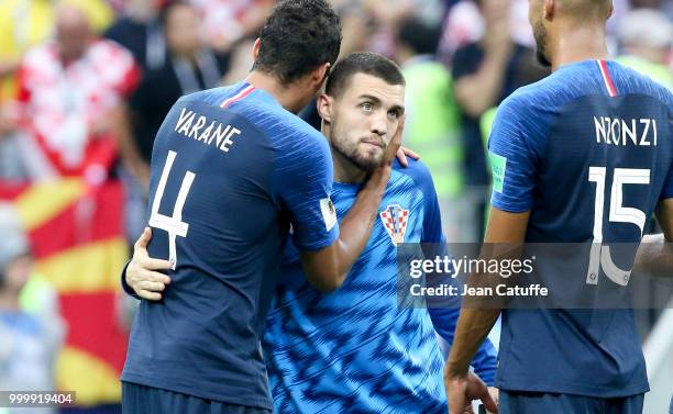 Raphael Varane of France, Mateo Kovacic of Croatia following the 2018 FIFA World Cup Russia Final between France and Croatia at Luzhniki Stadium on...