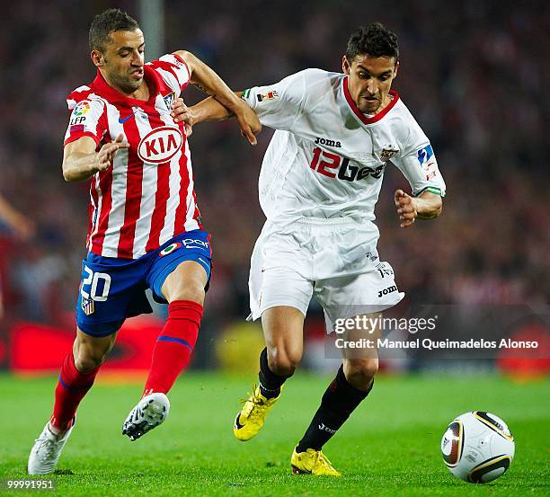 Jesus Navas of Sevilla and Simao Sabrosa of Atletico de Madrid compete for the ball during the Copa del Rey final between Atletico de Madrid and...