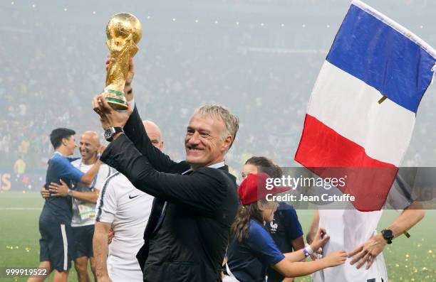 Coach of France Didier Deschamps holds the World Cup trophy following the 2018 FIFA World Cup Russia Final between France and Croatia at Luzhniki...