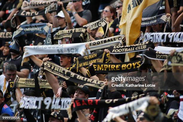 Los Angeles FC fans raise their scarves ahead of kickoff against the Portland Timbers at Banc of California Stadium on July 15, 2018 in Los Angeles,...