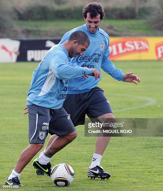 Uruguayan players Walter Gargano and Diego Godin take part in a training session of the Uruguayan football national team at the Football...