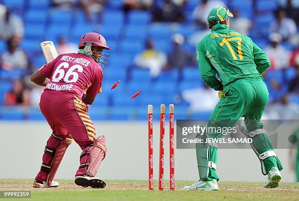 South African wicketkeeper AB de Villiers breaks the wicket to dismiss West Indies batsman Narsingh Deonarine during the first T20 match between West...