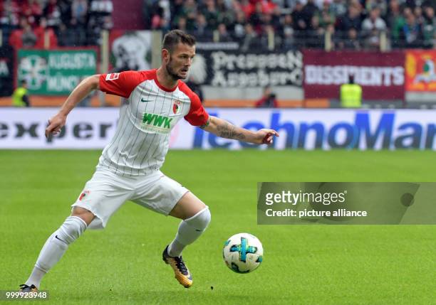 Augsburg's Marcel Heller in action during the German Bundesliga soccer match between FC Augsburg and 1. FC Cologne in the WWK Arena in Augsburg,...
