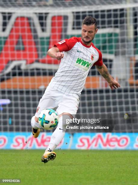 Augsburg's Marcel Heller in action during the German Bundesliga soccer match between FC Augsburg and 1. FC Cologne in the WWK Arena in Augsburg,...