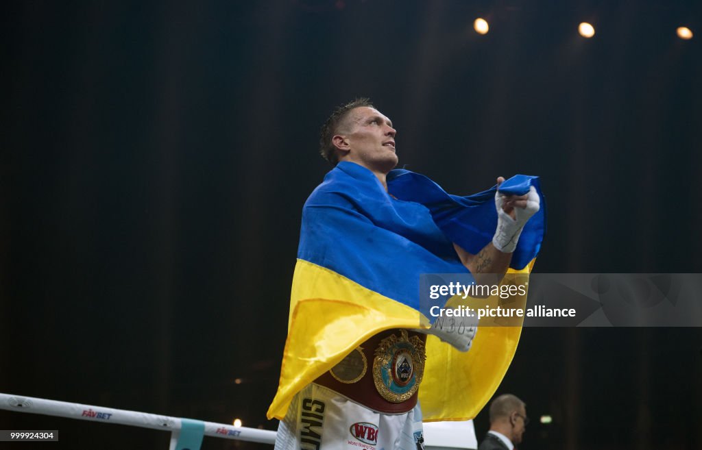Huck Riban Alexander Usyk celebrates after his victory over Huck during the ...