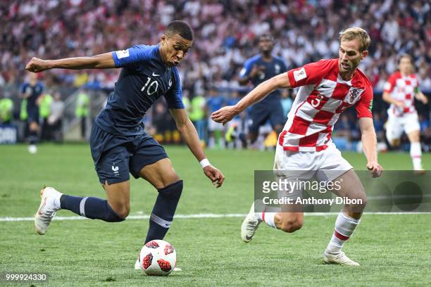 Kylian Mbappe of France and Ivan Strinic of Croatia during the World Cup Final match between France and Croatia at Luzhniki Stadium on July 15, 2018...