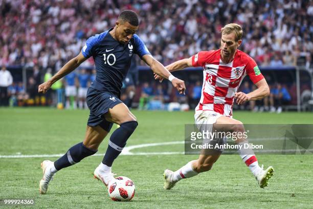 Kylian Mbappe of France and Ivan Strinic of Croatia during the World Cup Final match between France and Croatia at Luzhniki Stadium on July 15, 2018...